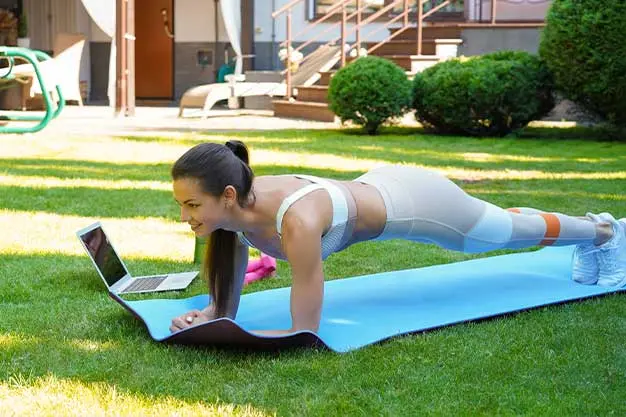 women doing exercise in her garden
